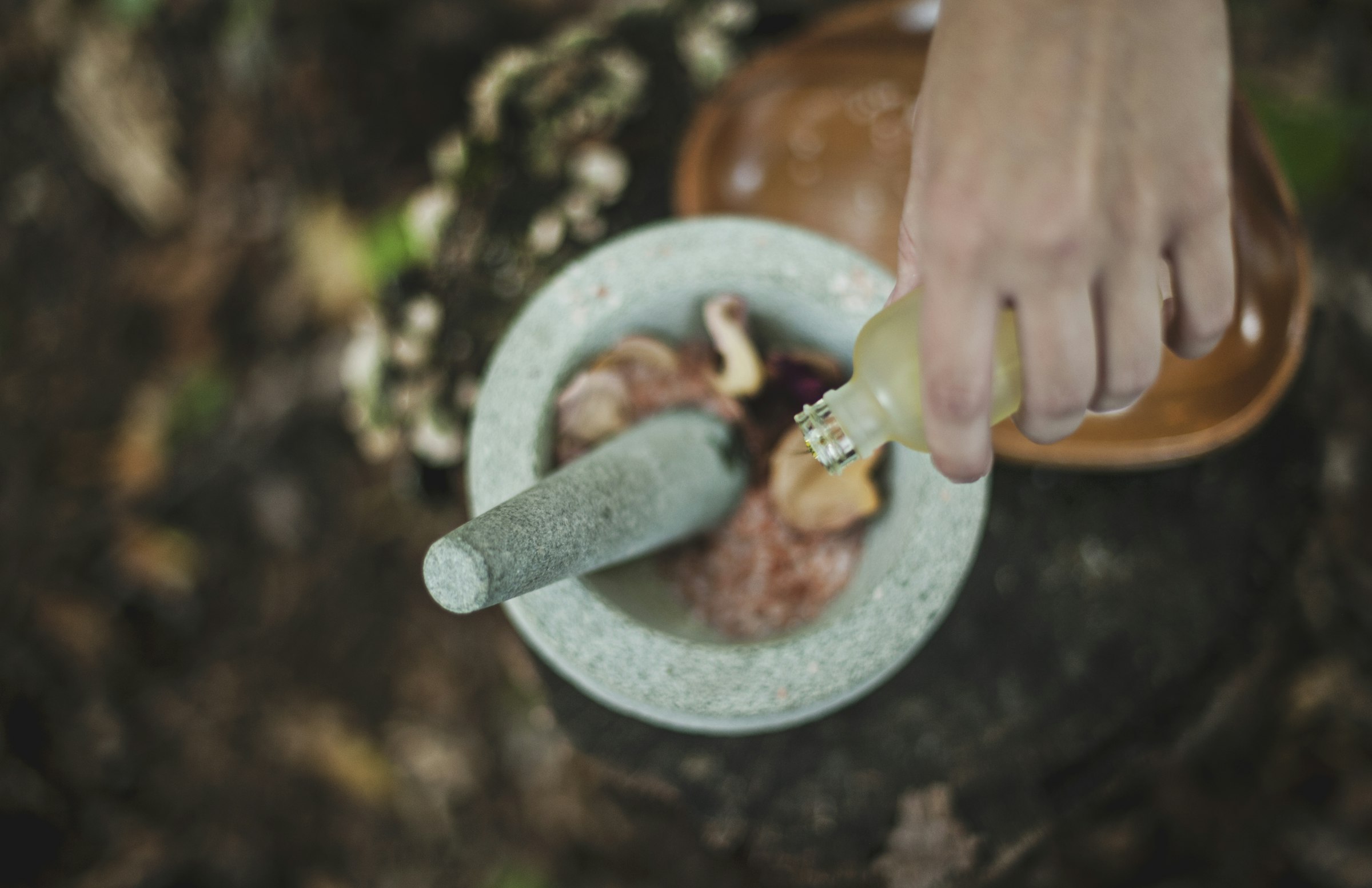 Herbs ground by hand with a stone mortar for Ayurvedic medicine