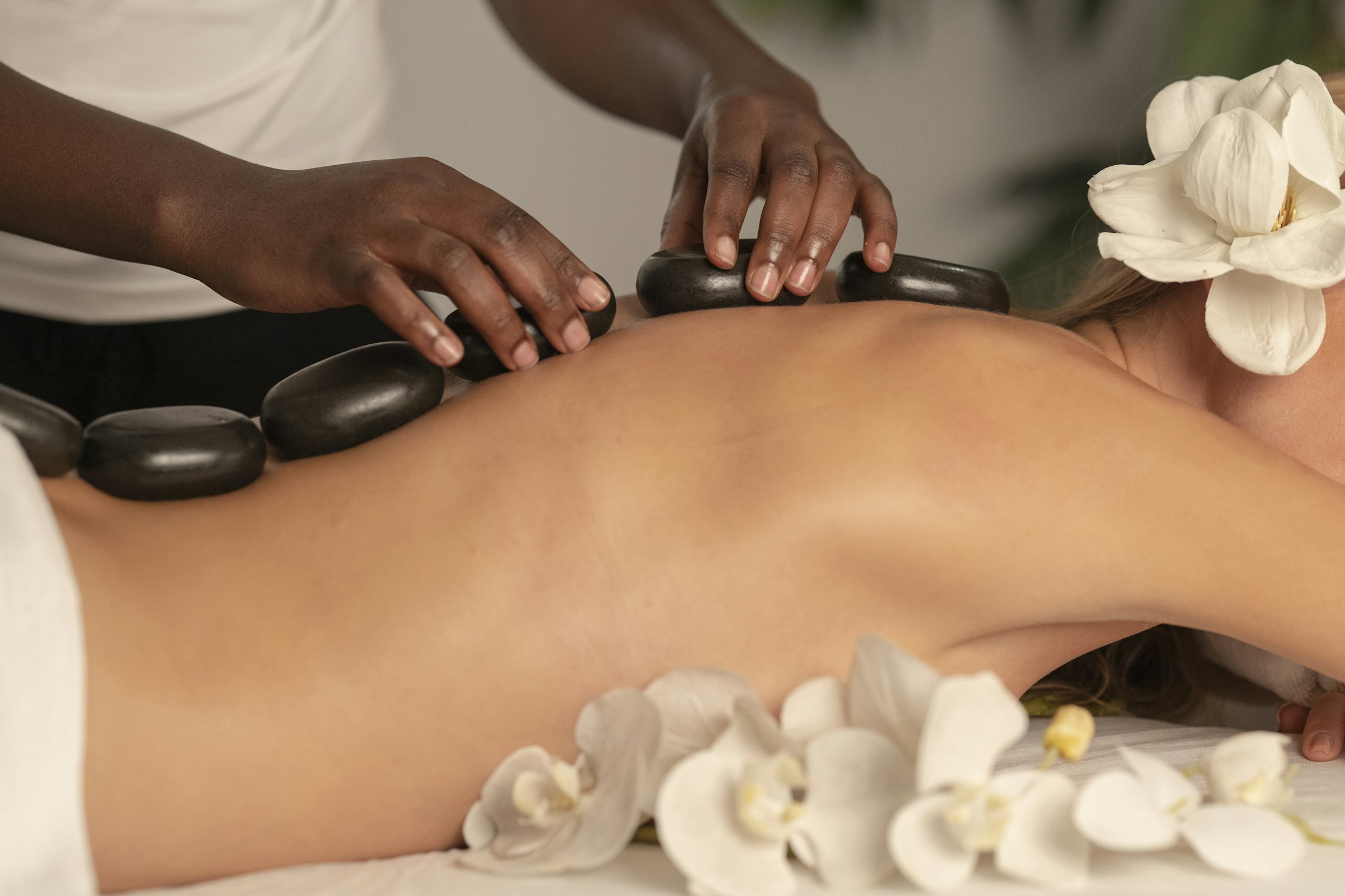 A therapist's hands during a warm-oil treatment at a partner centre
