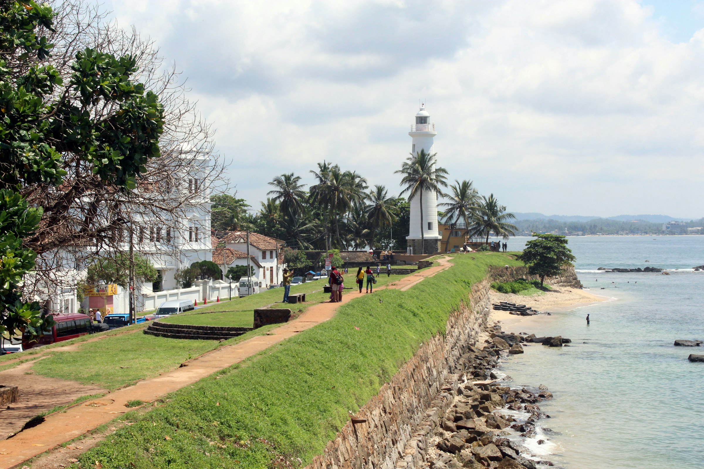 Palm trees along the ramparts of Galle Fort at golden hour