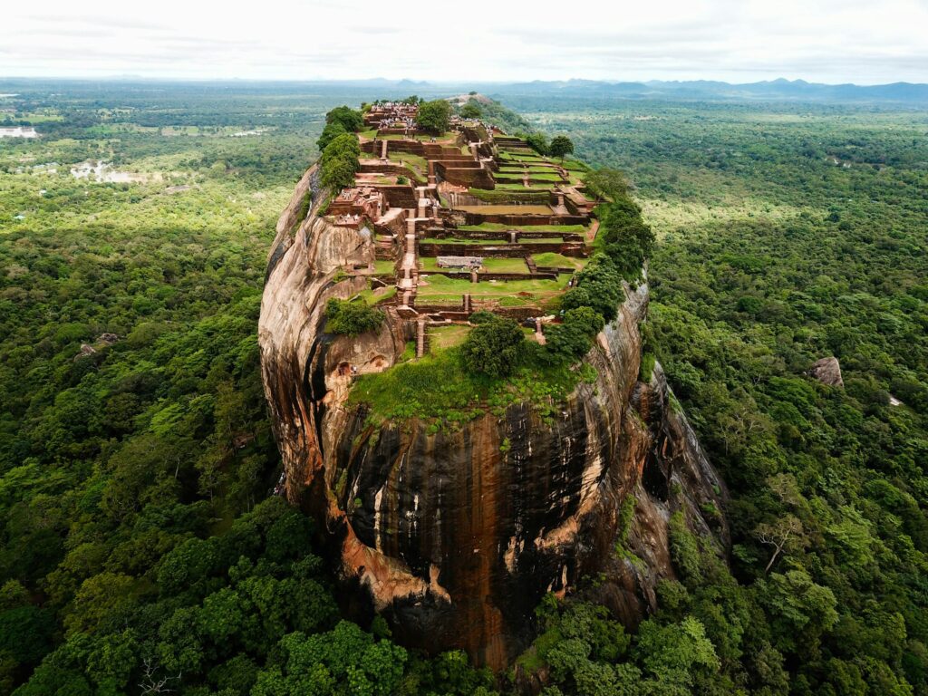 Aerial view of the Sigiriya rock fortress rising from surrounding forest