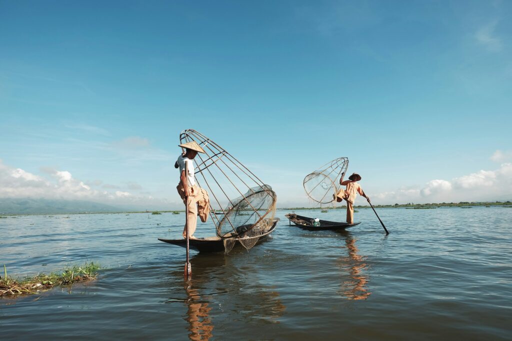 Traditional stilt fishermen at work in the shallow water off Weligama