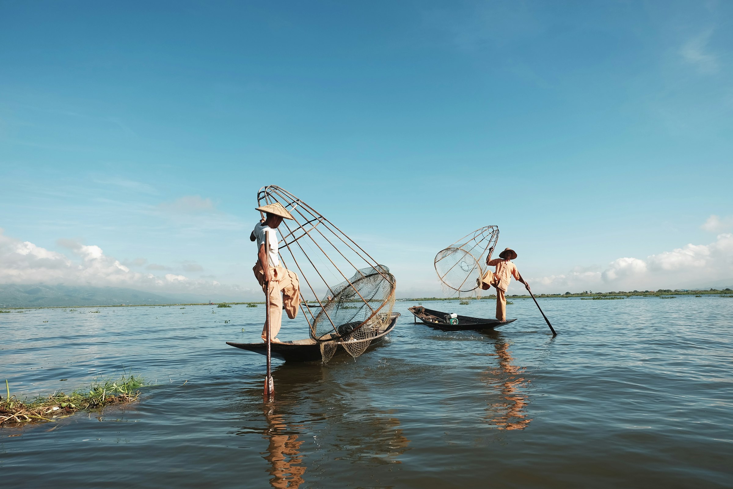Traditional stilt fishermen at work in the shallow water off Weligama