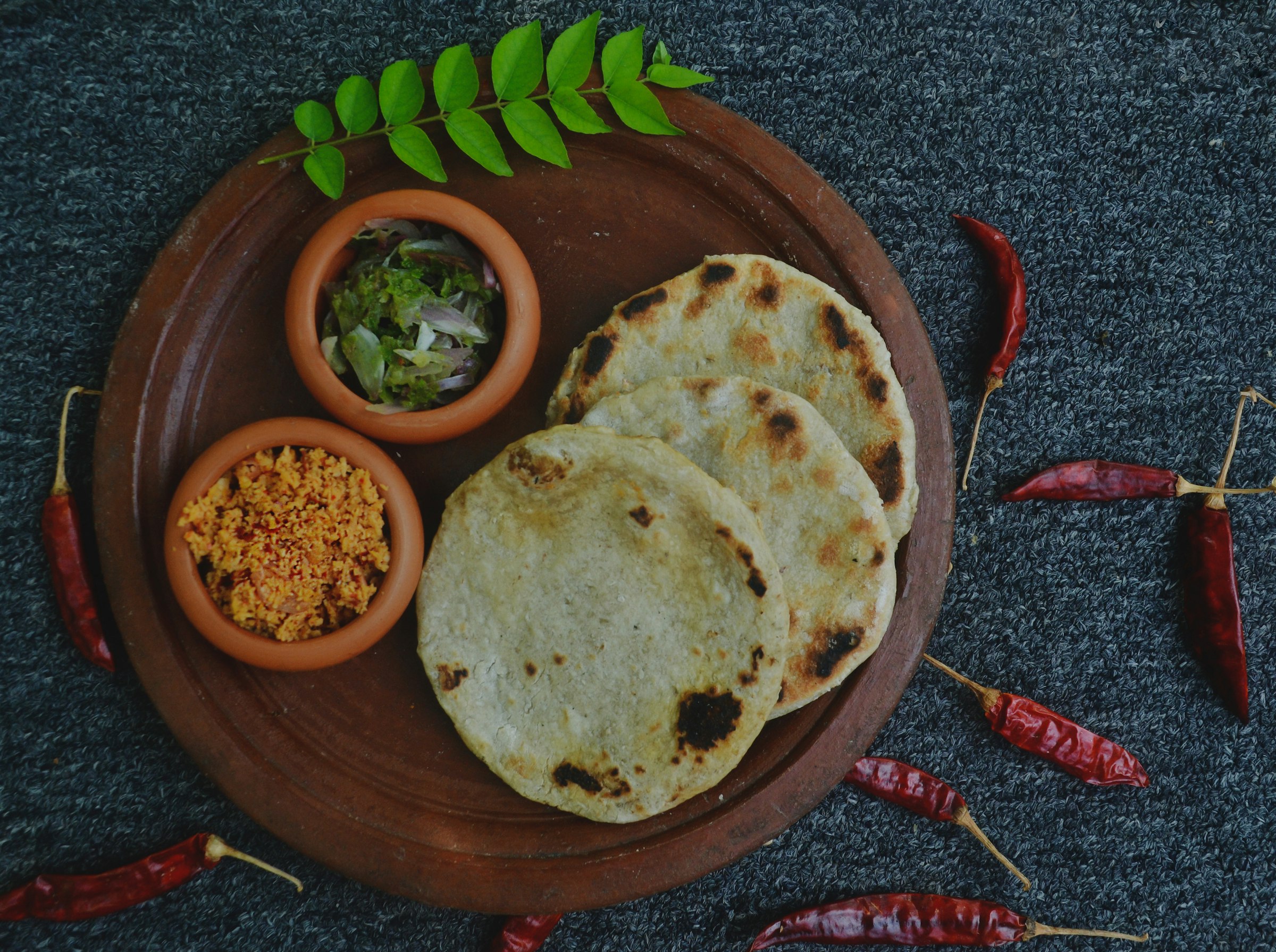 Sri Lankan vegetable curries and hoppers served in clay bowls