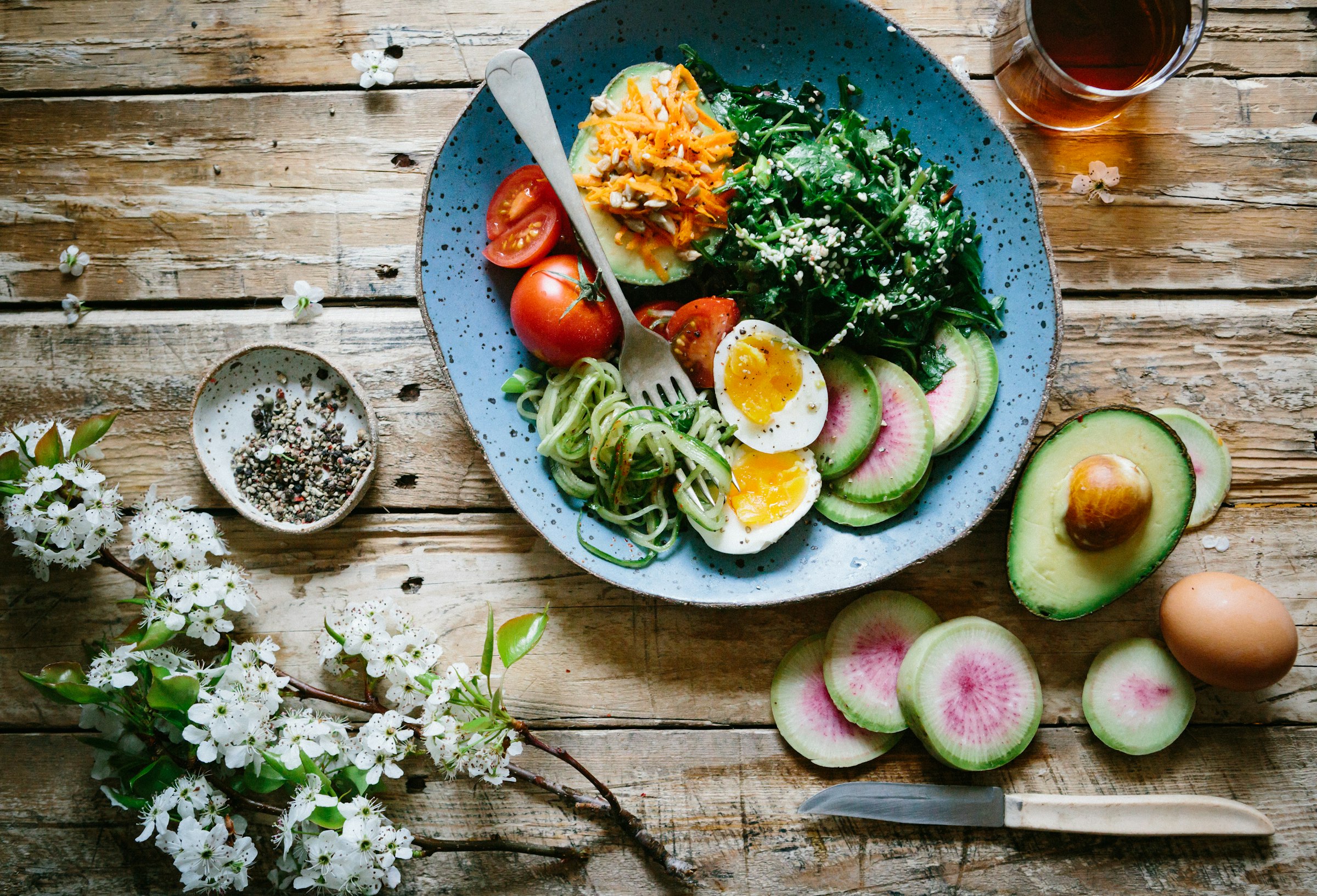 Fresh tropical fruit and vegetables arranged on a wooden surface